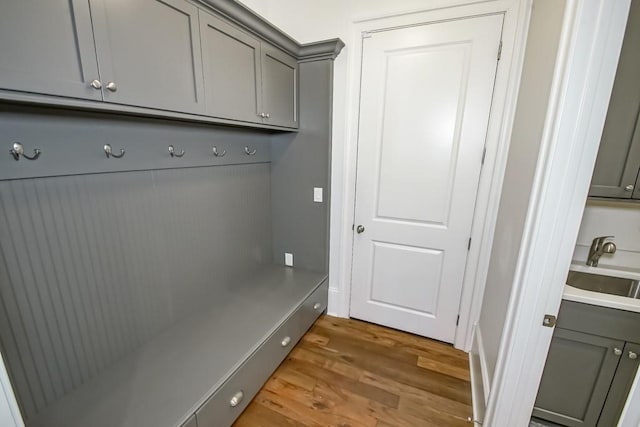 mudroom with sink and hardwood / wood-style flooring