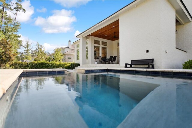 view of swimming pool featuring ceiling fan and a patio