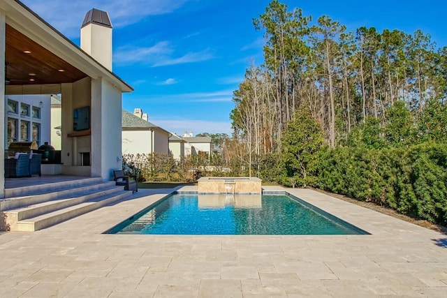 view of swimming pool with a patio