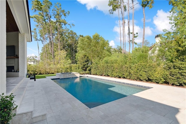 view of swimming pool with an in ground hot tub and a patio area