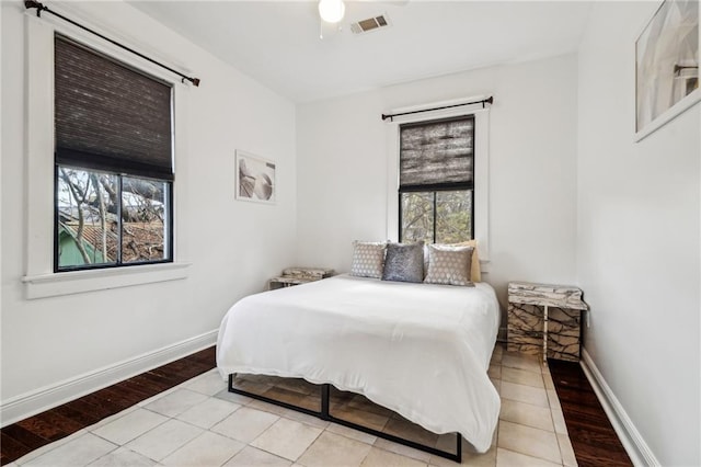 tiled bedroom with ceiling fan