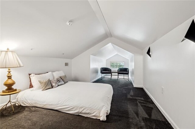 carpeted bedroom featuring lofted ceiling