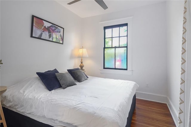 bedroom with ceiling fan and dark hardwood / wood-style floors