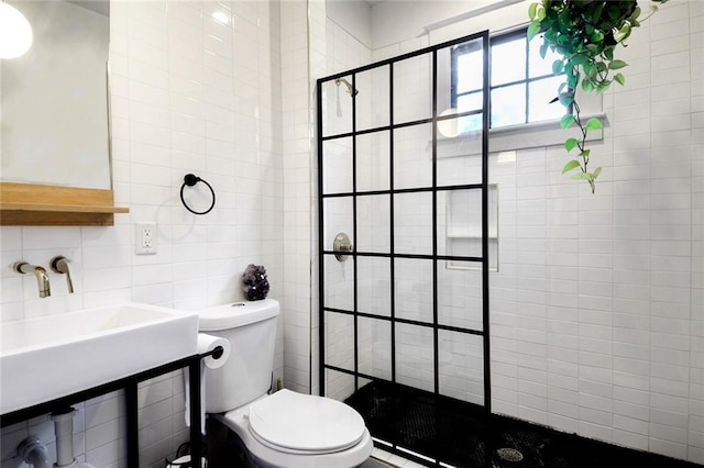 bathroom with toilet, walk in shower, tile walls, decorative backsplash, and sink