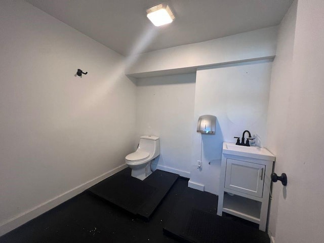 bathroom featuring toilet and vanity