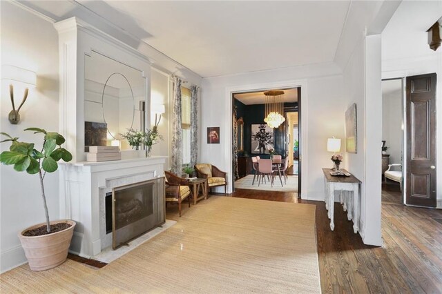 interior space with a chandelier, hardwood / wood-style floors, and a premium fireplace