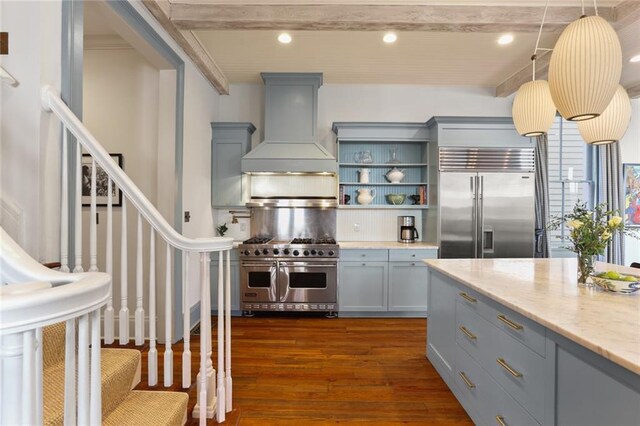 kitchen with decorative light fixtures, custom exhaust hood, beamed ceiling, premium appliances, and light stone countertops