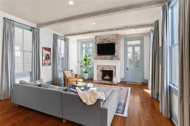 living room with beam ceiling, a fireplace, and dark hardwood / wood-style flooring