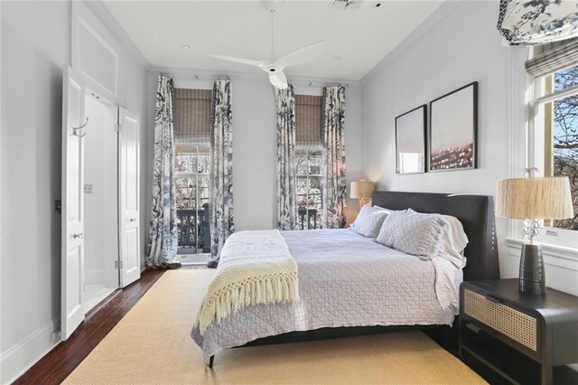 bedroom featuring dark hardwood / wood-style floors and crown molding