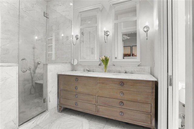 bathroom featuring vanity and a shower with door