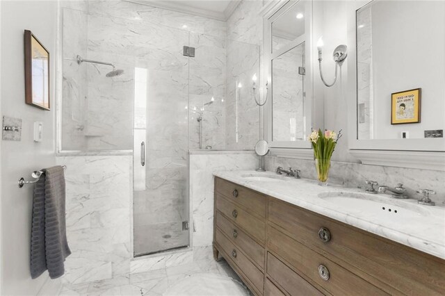 bathroom with a shower with shower door and vanity