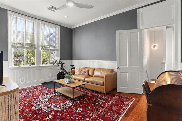 living room with ceiling fan, hardwood / wood-style flooring, and crown molding