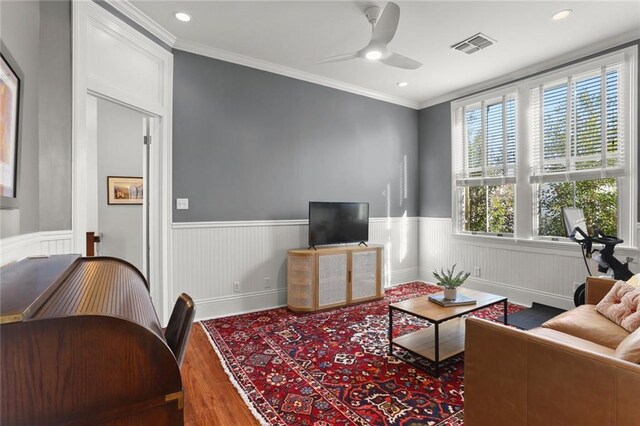 living room featuring ceiling fan, hardwood / wood-style floors, and ornamental molding