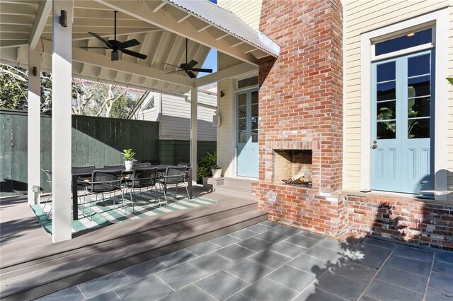 view of patio with french doors and an outdoor brick fireplace