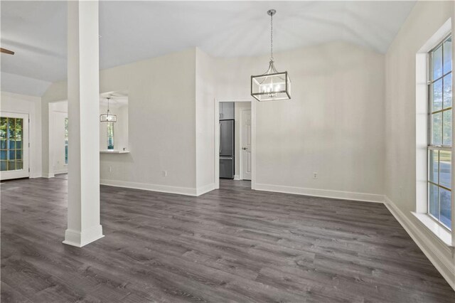 unfurnished dining area with dark hardwood / wood-style floors and vaulted ceiling