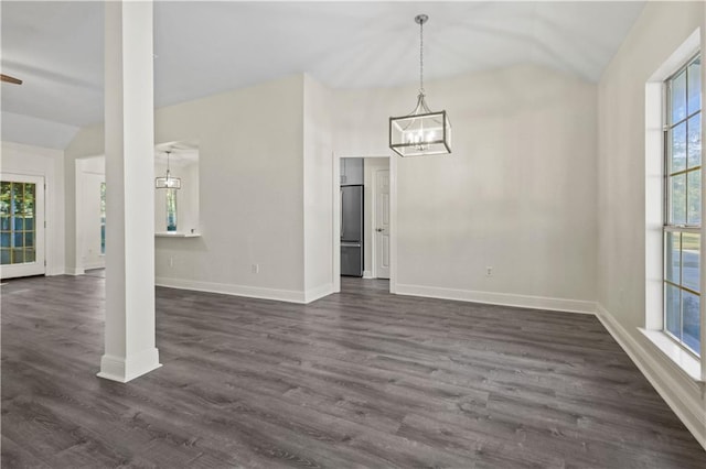 unfurnished dining area featuring vaulted ceiling and dark hardwood / wood-style floors