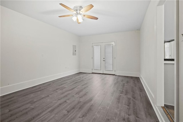 unfurnished room featuring french doors, ceiling fan, electric panel, and dark wood-type flooring