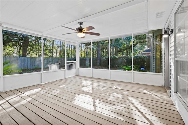 unfurnished sunroom with ceiling fan