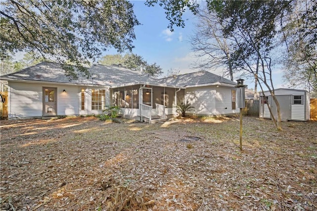 view of front of property featuring a sunroom and a storage unit