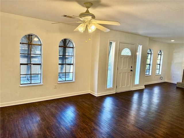 foyer entrance featuring dark wood-type flooring and ceiling fan