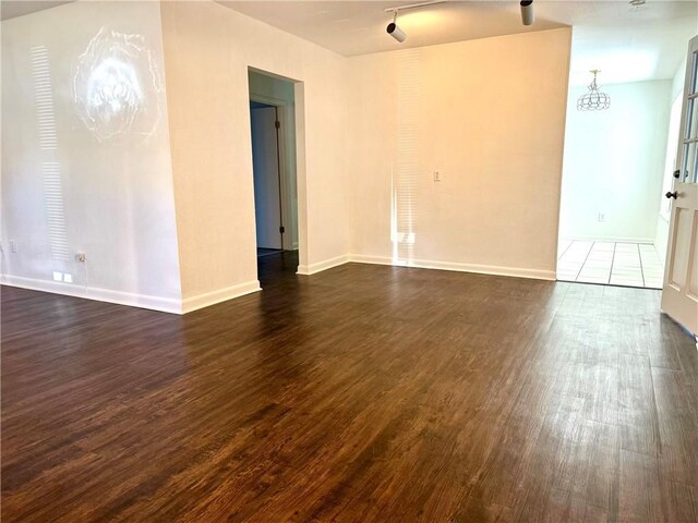 spare room featuring dark hardwood / wood-style floors