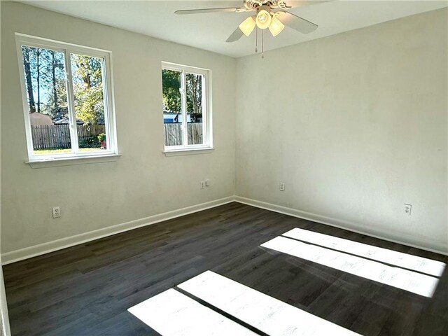 unfurnished room featuring ceiling fan and dark hardwood / wood-style floors