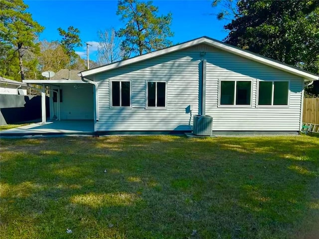 back of property featuring a lawn and a patio