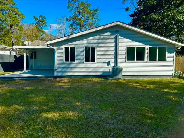 back of property featuring a lawn and a patio