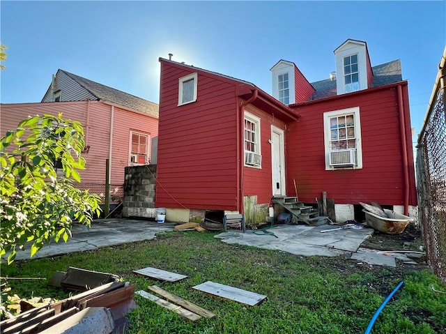 rear view of property with cooling unit, a lawn, and a patio