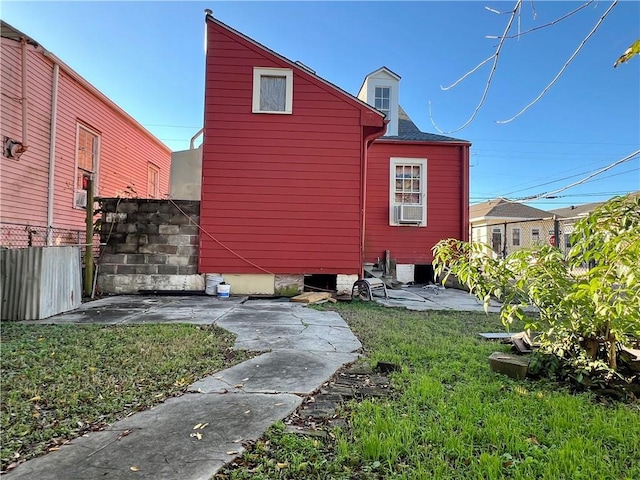 view of home's exterior with cooling unit, a yard, and a patio