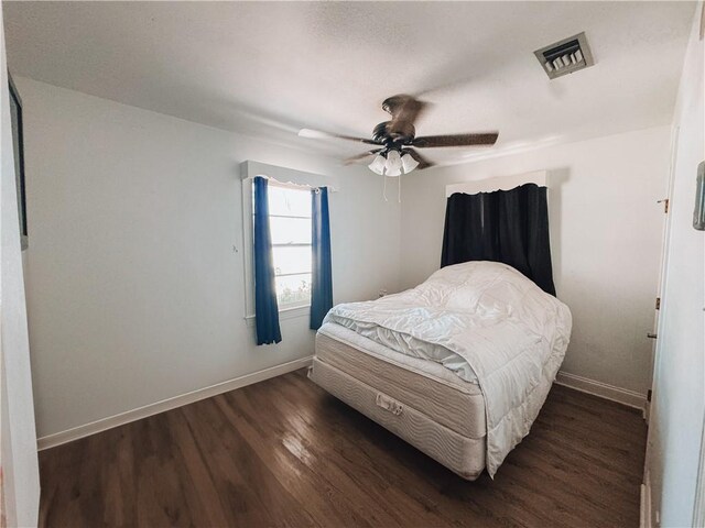 bedroom with ceiling fan and dark hardwood / wood-style flooring