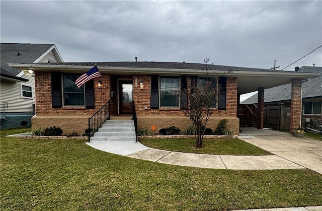 view of front of property with a front yard and a carport