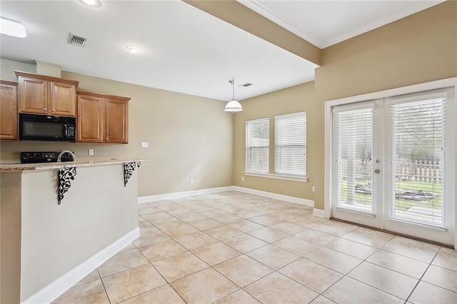 kitchen with light tile patterned flooring, pendant lighting, french doors, and black appliances