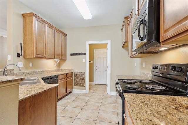 kitchen featuring light tile patterned floors, sink, light stone counters, and black appliances