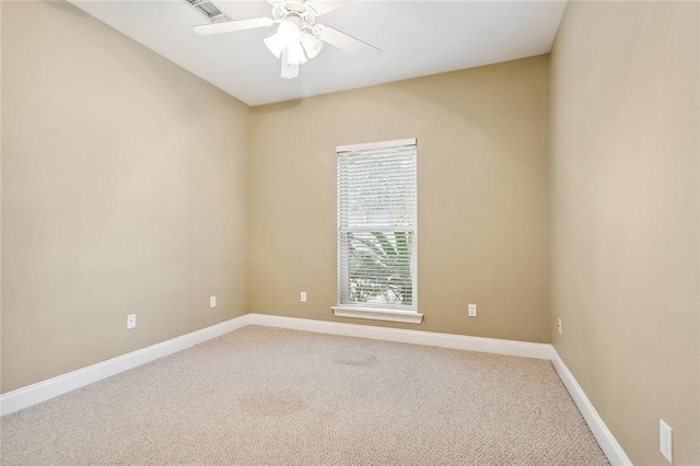 carpeted empty room featuring ceiling fan