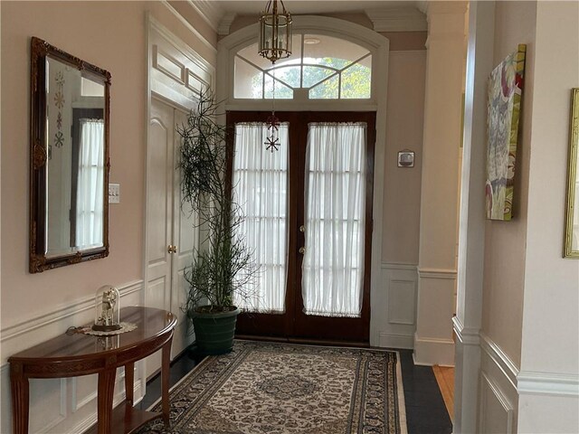 doorway to outside featuring dark wood-type flooring, a chandelier, and french doors