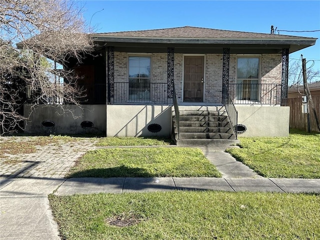 bungalow-style home with covered porch and a front yard