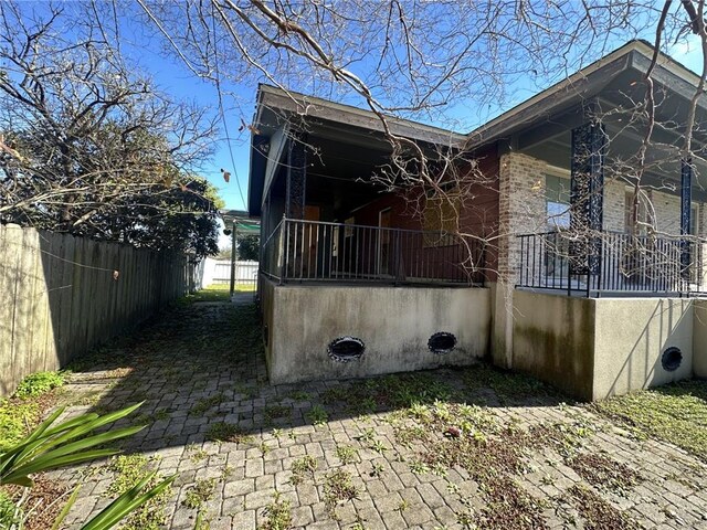 view of side of home featuring a porch