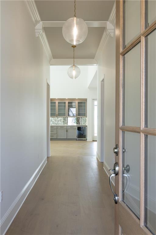 5044 Twin River Pl, Covington, LA 70433 - hallway featuring ornamental molding, baseboards, and wood finished floors