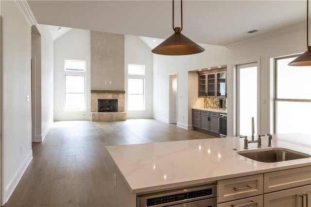 5044 Twin River Pl, Covington, LA 70433 - kitchen featuring a sink, open floor plan, wood finished floors, baseboards, and hanging light fixtures
