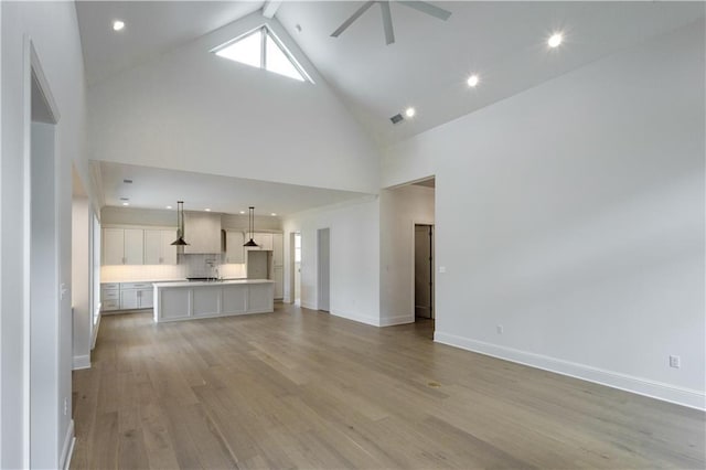 5044 Twin River Pl, Covington, LA 70433 - unfurnished living room featuring high vaulted ceiling, ceiling fan, baseboards, recessed lighting, and light wood-style flooring