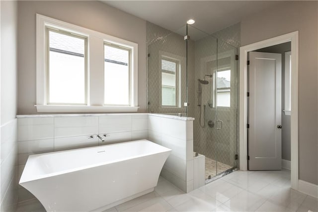 5044 Twin River Pl, Covington, LA 70433 - bathroom featuring a freestanding tub, plenty of natural light, a shower stall, and baseboards