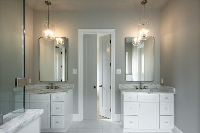 5044 Twin River Pl, Covington, LA 70433 - full bath with baseboards, two vanities, tile patterned floors, and a chandelier