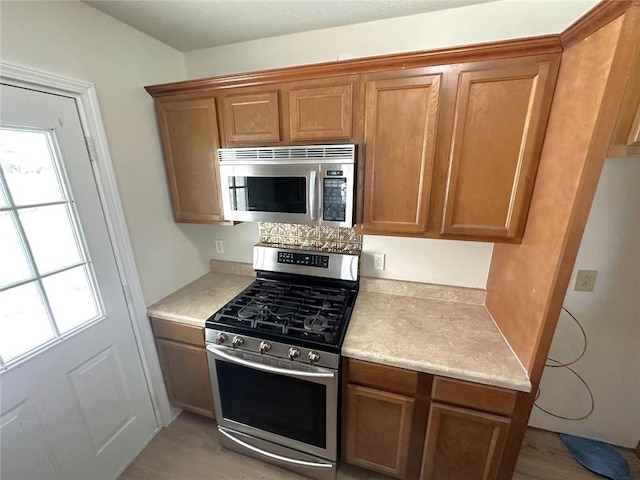 kitchen with light hardwood / wood-style floors and stainless steel appliances