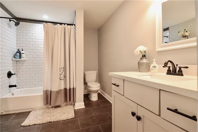 full bathroom featuring tile patterned floors, toilet, vanity, and shower / tub combo with curtain