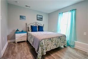 bedroom with hardwood / wood-style flooring