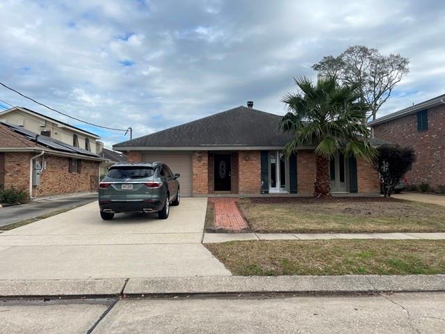 view of front facade with a garage and a front lawn