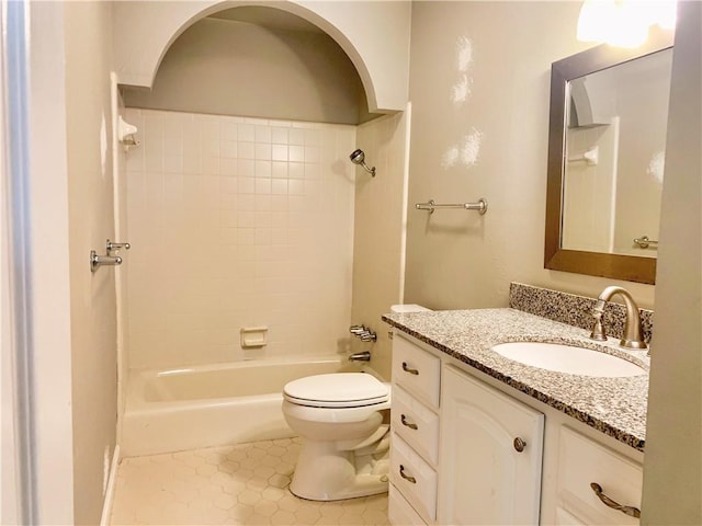 full bath featuring toilet, tile patterned flooring, washtub / shower combination, and vanity