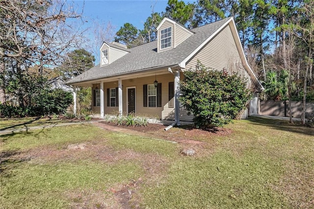 cape cod home with covered porch and a front yard