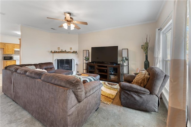 living room featuring light carpet, ceiling fan, and crown molding